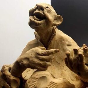 Tan Ceramic Figurine with Expressive Features